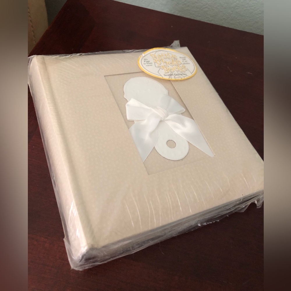 beige baby photo album features a front window for a personalized picture